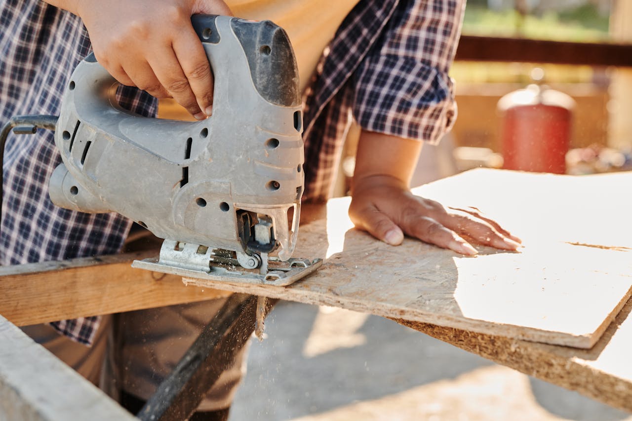 Person Holding Gray Metal Tool